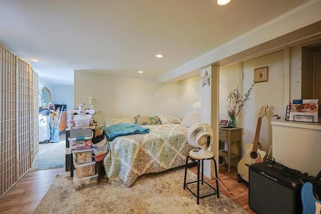 bedroom featuring wood finished floors, recessed lighting, and crown molding
