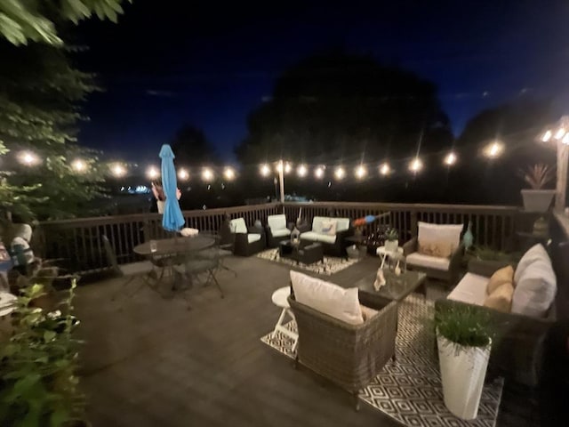patio at night featuring an outdoor hangout area and outdoor dining area