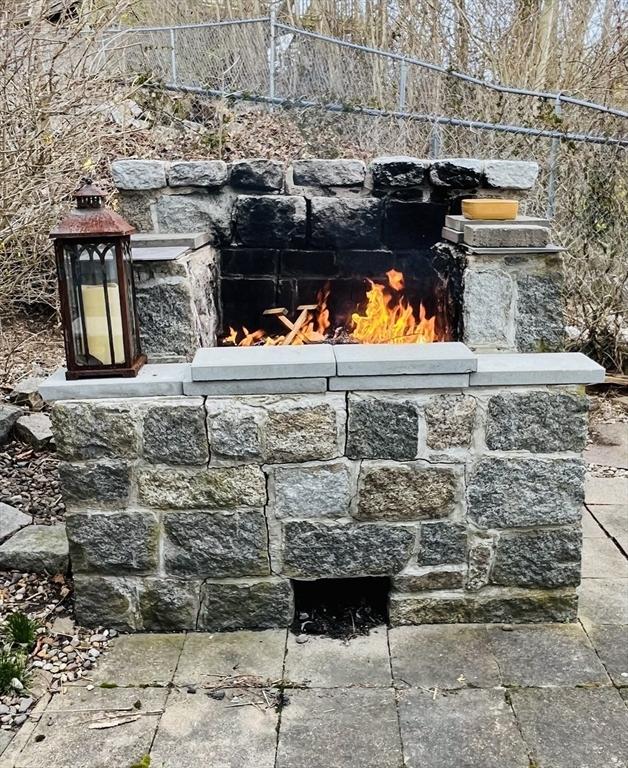 bar with a fireplace and stone tile floors