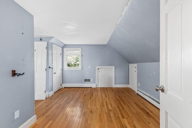 57 Rudon Dr, North Attleboro, MA 02760 - additional living space featuring baseboard heating, light wood-type flooring, vaulted ceiling, and a baseboard heating unit