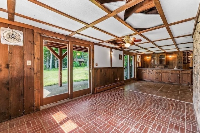 57 Rudon Dr, North Attleboro, MA 02760 - unfurnished living room featuring a baseboard heating unit, wood walls, a ceiling fan, wainscoting, and brick patterned flooring