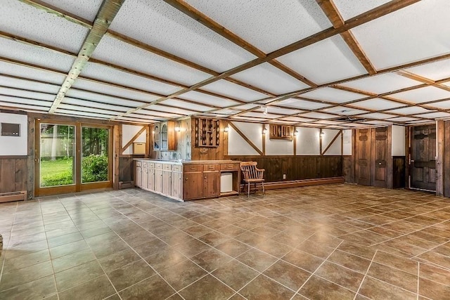 57 Rudon Dr, North Attleboro, MA 02760 - unfurnished living room featuring wood walls, a wainscoted wall, coffered ceiling, dark tile patterned flooring, and baseboard heating