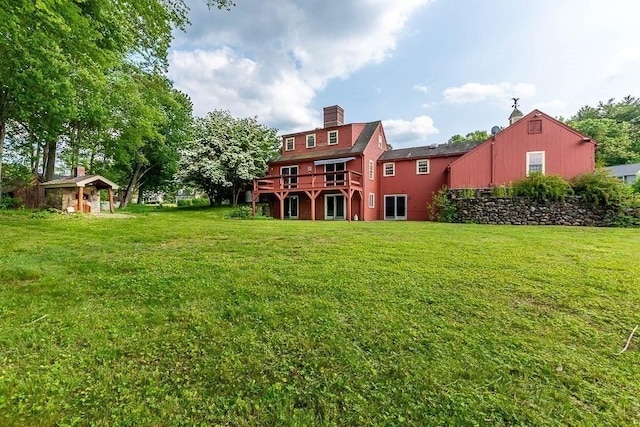 57 Rudon Dr, North Attleboro, MA 02760 - rear view of property with a yard, a chimney, and a deck