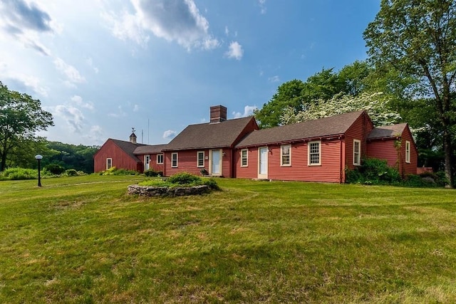 57 Rudon Dr, North Attleboro, MA 02760 - rear view of house with a lawn and a chimney