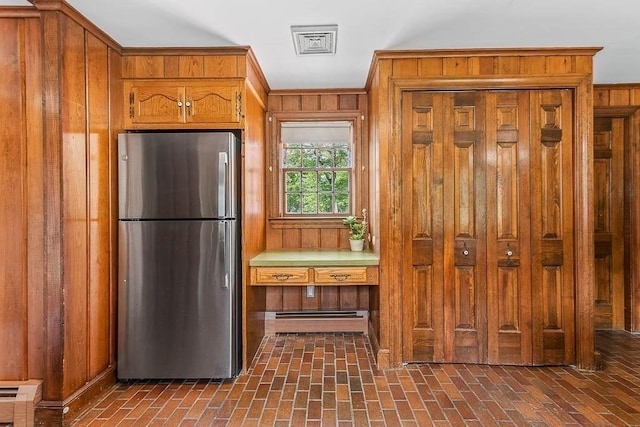 57 Rudon Dr, North Attleboro, MA 02760 - kitchen featuring freestanding refrigerator, brown cabinets, brick floors, and wood walls