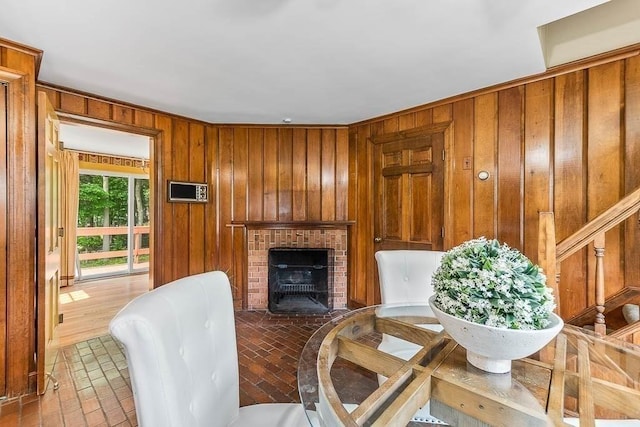 57 Rudon Dr, North Attleboro, MA 02760 - living room with wooden walls, a fireplace, and brick patterned flooring