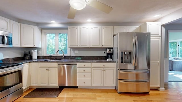 1000 Forest St, North Andover, MA 01845 - kitchen featuring stainless steel appliances, a sink, light wood-style flooring, white cabinetry, and recessed lighting