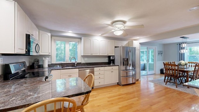 1000 Forest St, North Andover, MA 01845 - kitchen featuring stainless steel appliances, a sink, light wood-style floors, white cabinets, and a ceiling fan
