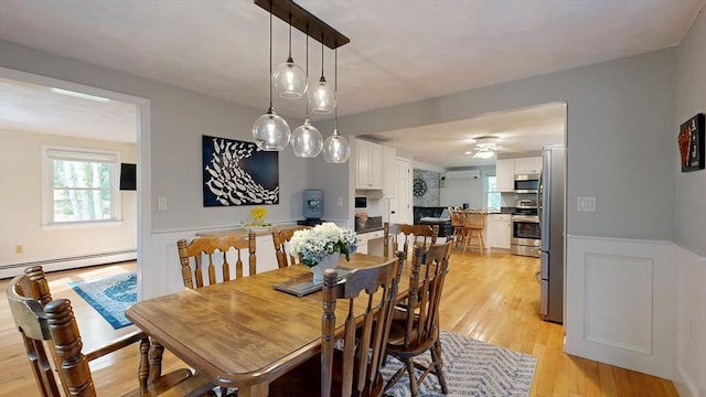 1000 Forest St, North Andover, MA 01845 - dining area with a baseboard radiator, light wood-type flooring, a wainscoted wall, and ceiling fan