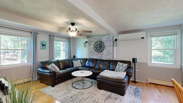 1000 Forest St, North Andover, MA 01845 - living area featuring a wall mounted air conditioner, a baseboard heating unit, light wood-type flooring, and a ceiling fan