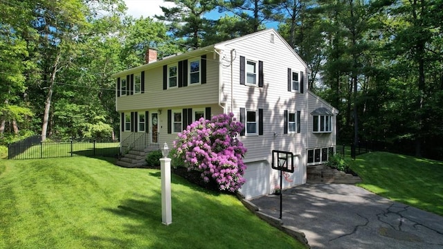 1000 Forest St, North Andover, MA 01845 - colonial house featuring a chimney, driveway, an attached garage, and view of scattered trees