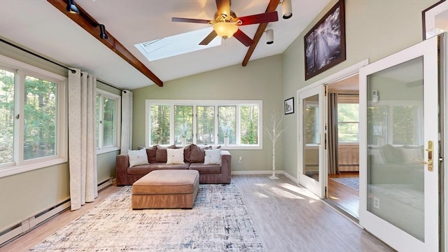 1000 Forest St, North Andover, MA 01845 - sunroom with a skylight, wood finished floors, plenty of natural light, lofted ceiling, and baseboards