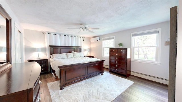 1000 Forest St, North Andover, MA 01845 - bedroom with an AC wall unit, light wood finished floors, and a baseboard heating unit