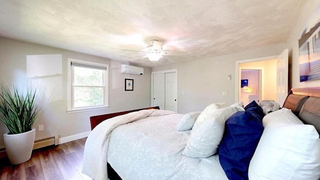 1000 Forest St, North Andover, MA 01845 - bedroom with a wall mounted air conditioner, wood finished floors, baseboards, a ceiling fan, and a closet