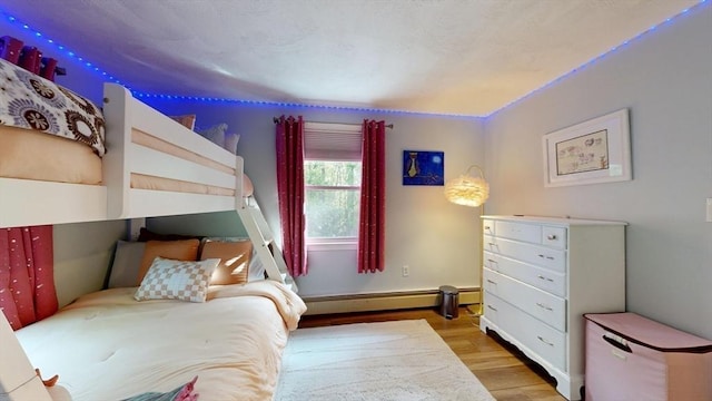 1000 Forest St, North Andover, MA 01845 - bedroom with wood finished floors and a baseboard heating unit