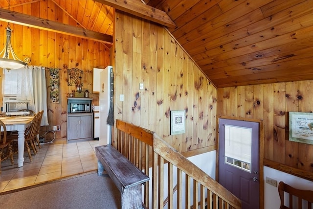 corridor featuring wood ceiling, light tile patterned floors, wooden walls, and vaulted ceiling with beams