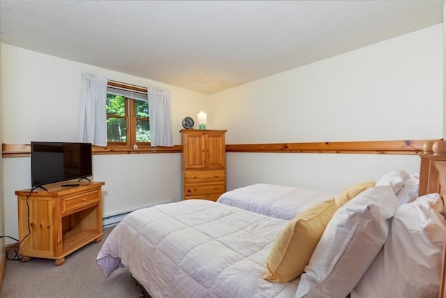 carpeted bedroom with a textured ceiling and a baseboard radiator