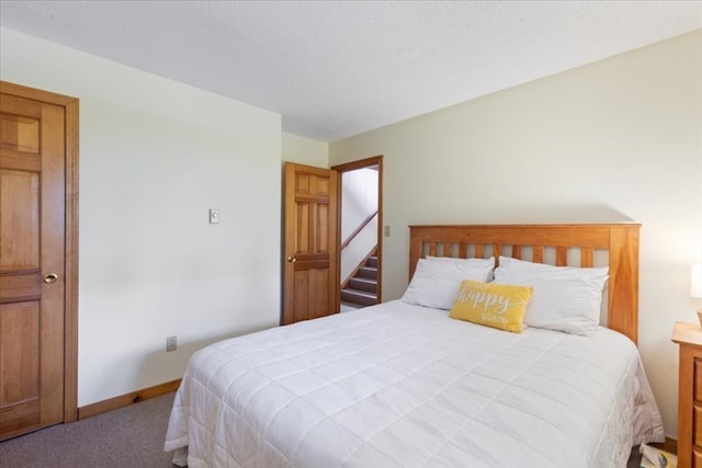 carpeted bedroom featuring a textured ceiling