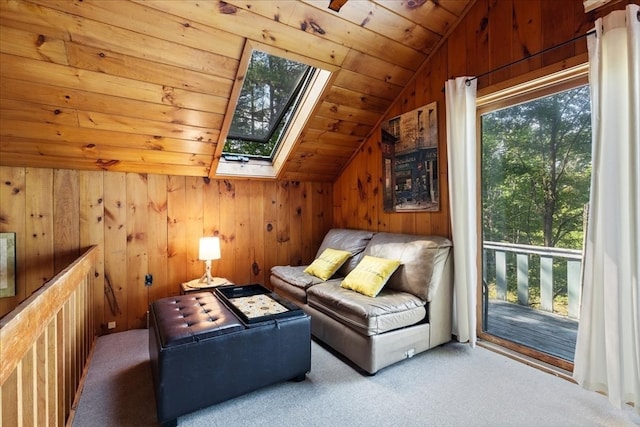 interior space with wood ceiling, wooden walls, carpet, and lofted ceiling with skylight