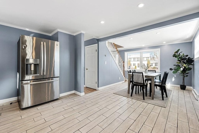 dining room featuring stairway, baseboards, wood tiled floor, and crown molding