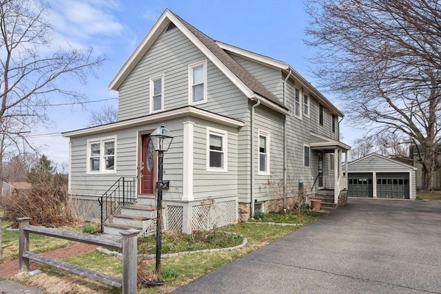 view of front facade featuring an outbuilding and a garage