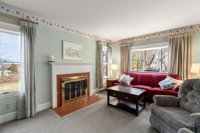 carpeted living area with baseboards, a fireplace, and a baseboard radiator