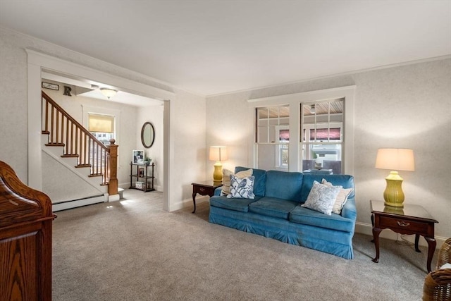 carpeted living area featuring a wealth of natural light, stairway, crown molding, and a baseboard radiator