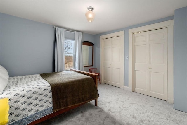 bedroom with two closets and carpet floors