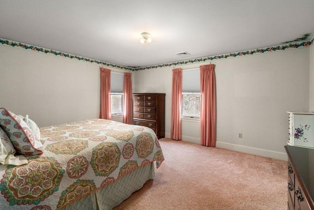 bedroom featuring baseboards, visible vents, and light carpet