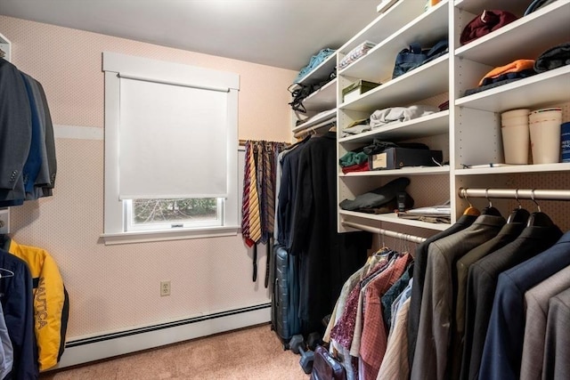 spacious closet with a baseboard heating unit and carpet flooring