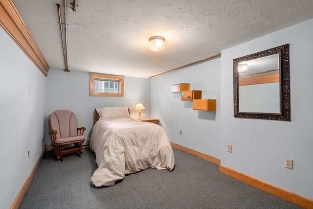 bedroom with baseboards, carpet floors, and a textured ceiling