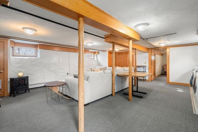 basement featuring baseboards, carpet floors, and a textured ceiling