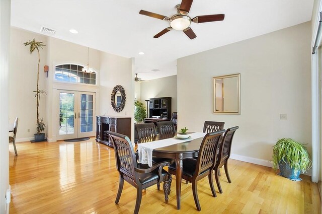 dining space with ceiling fan, light wood-type flooring, and french doors