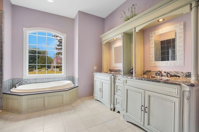 bathroom with tile patterned floors, dual bowl vanity, and a bathing tub