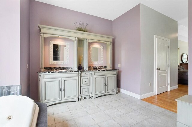 bathroom with dual bowl vanity and tile patterned flooring