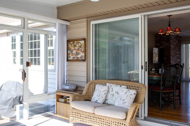 sunroom featuring an inviting chandelier