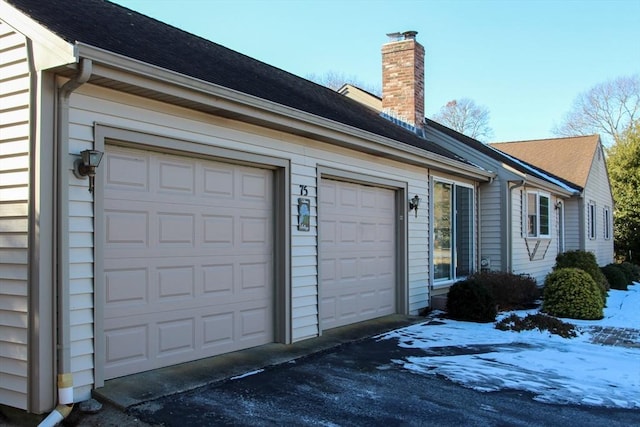 view of side of home featuring a garage