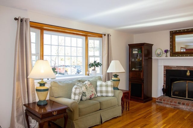 sitting room featuring a fireplace and hardwood / wood-style floors