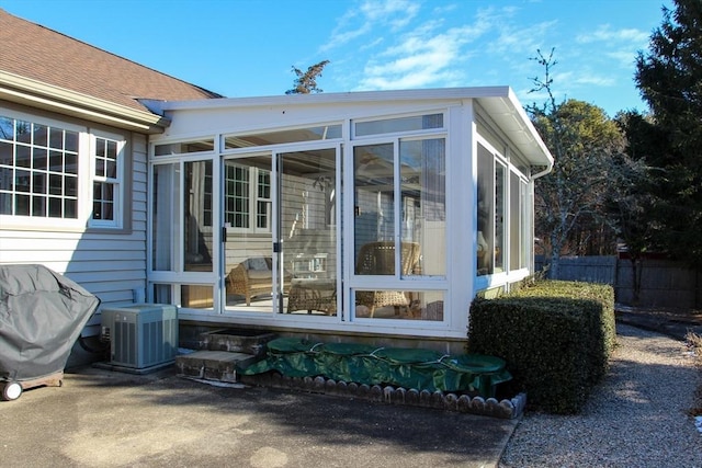 exterior space with central AC and a sunroom