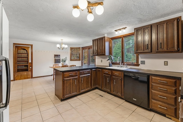 kitchen featuring black dishwasher, sink, dark brown cabinets, kitchen peninsula, and an inviting chandelier