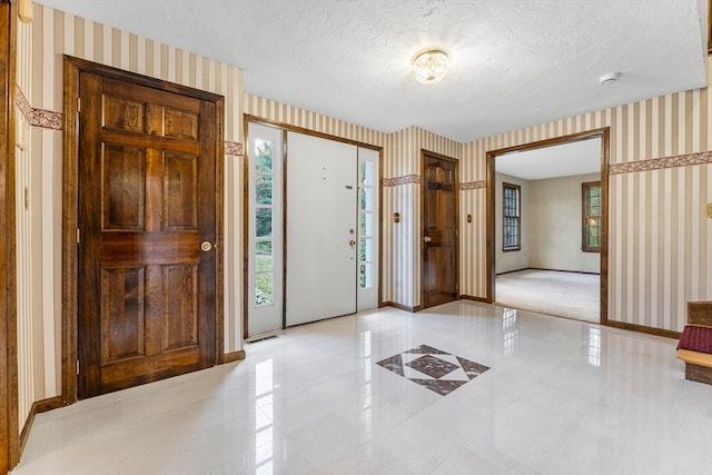 entryway featuring a textured ceiling