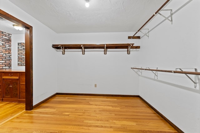 walk in closet featuring light hardwood / wood-style floors