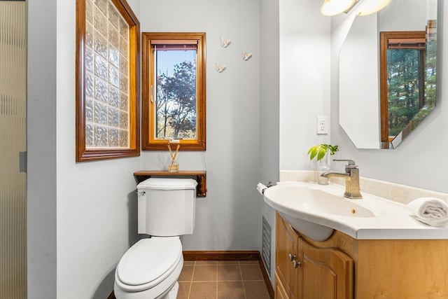 bathroom featuring vanity, toilet, and tile patterned floors