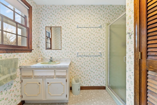 bathroom with vanity, a shower with shower door, and tile patterned floors