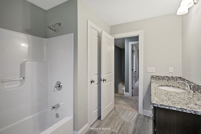 bathroom featuring vanity, hardwood / wood-style flooring, and bathing tub / shower combination