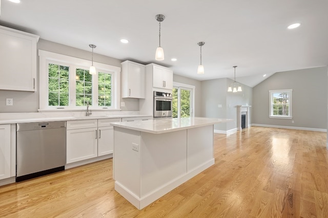 kitchen with white cabinetry, stainless steel appliances, and light hardwood / wood-style flooring