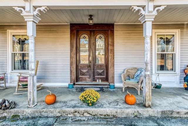 view of exterior entry with a porch