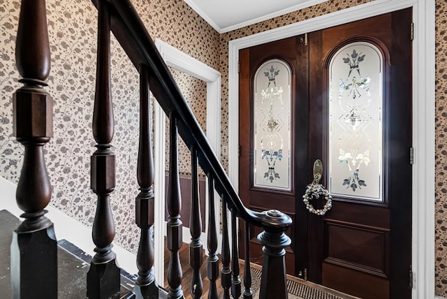 entrance foyer featuring ornamental molding