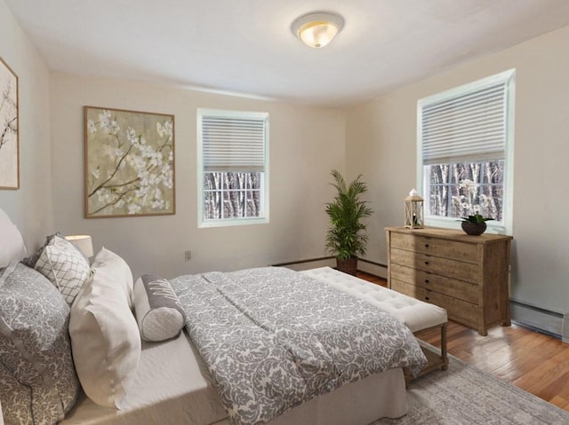 bedroom featuring light hardwood / wood-style floors and a baseboard radiator