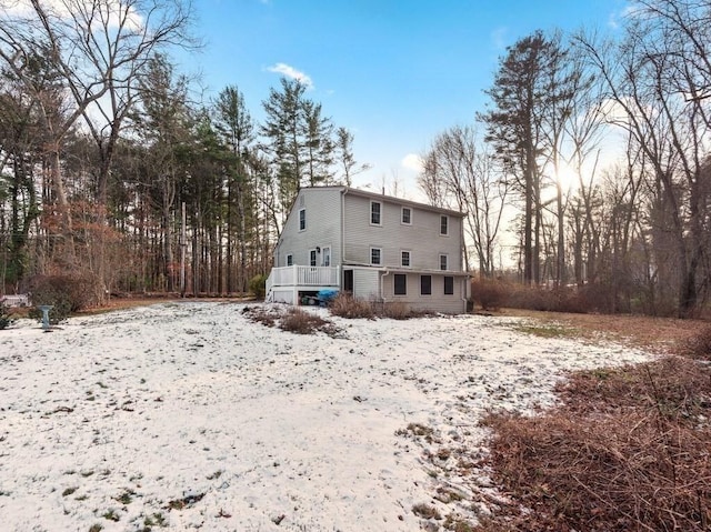 view of snow covered rear of property